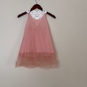 Dull pink tulle dress with pearls and lace decor on the back